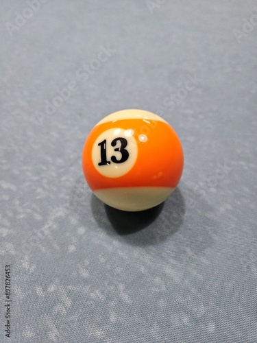 Pool balls on gray table sport game set known as eight ball pool. Number  Thirteen.