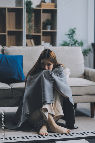 A woman with a cold with pills is treated at home chooses which drugs to take and self-medicates, checks the expiration date while sitting on the couch at home