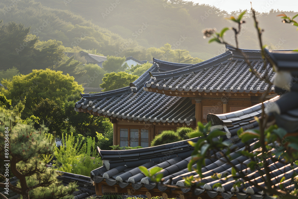 A traditional Korean hanok house is set against a lush green landscape, with intricate tiled roofs and morning sunlight casting a warm glow, creating a serene and picturesque scene A traditional Korean hanok house is set against a lush green landscape, with intricate tiled roofs and morning sunlight casting a warm glow, creating a serene and picturesque scene