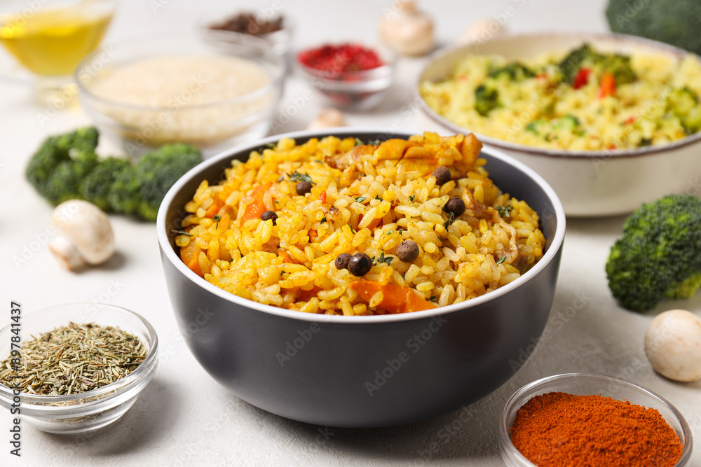 Pilaf in bowls, rice, spice and vegetables on white background, close up Pilaf in bowls, rice, spice and vegetables on white background, close up