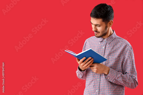 Young man reading book on r...