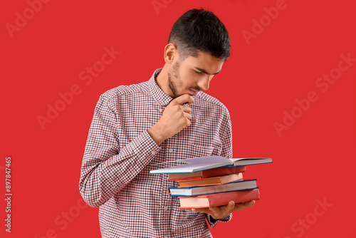 Thoughtful young man readin...