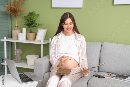 Pregnant woman working from...