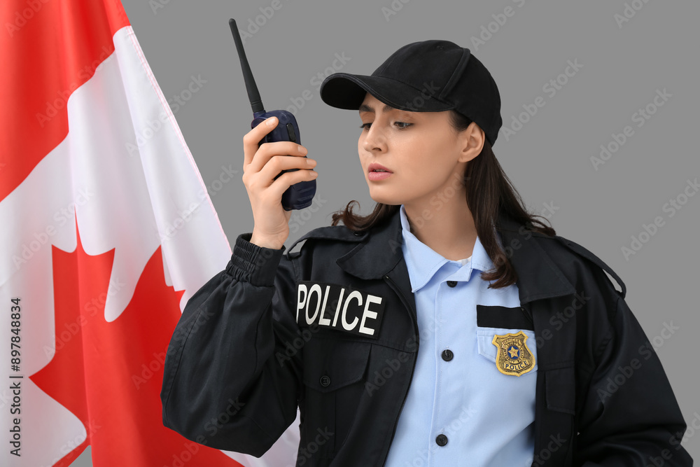Obraz premium Female police officer with walkie-talkie and flag of Canada on grey background