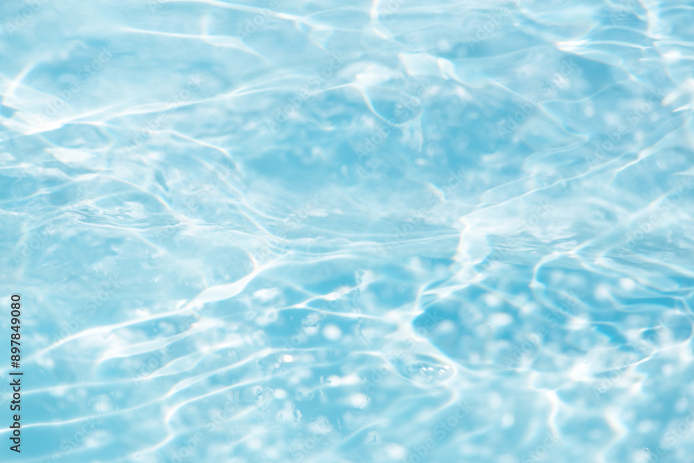 Blue water with ripples on the surface. Defocus blurred transparent blue colored clear calm water surface texture with splashes and bubbles. Water waves with shining pattern texture background. Blue water with ripples on the surface. Defocus blurred transparent blue colored clear calm water surface texture with splashes and bubbles. Water waves with shining pattern texture background.