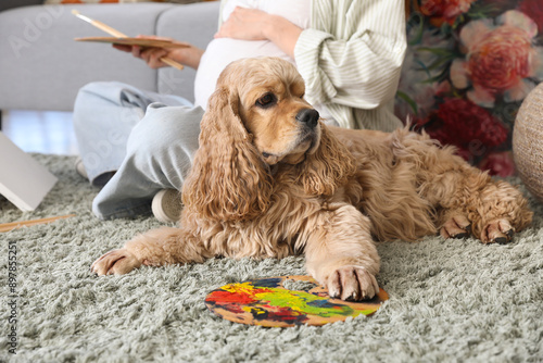 Dog and paint palette on ca...