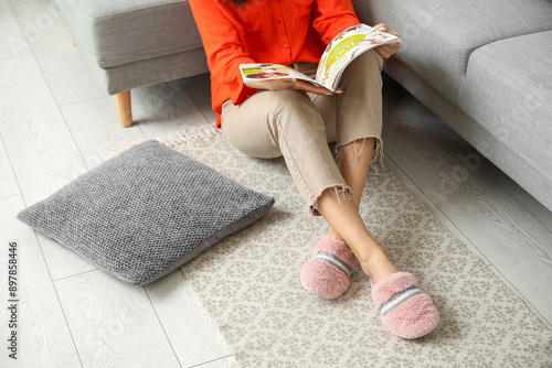 Young woman in slippers rea...