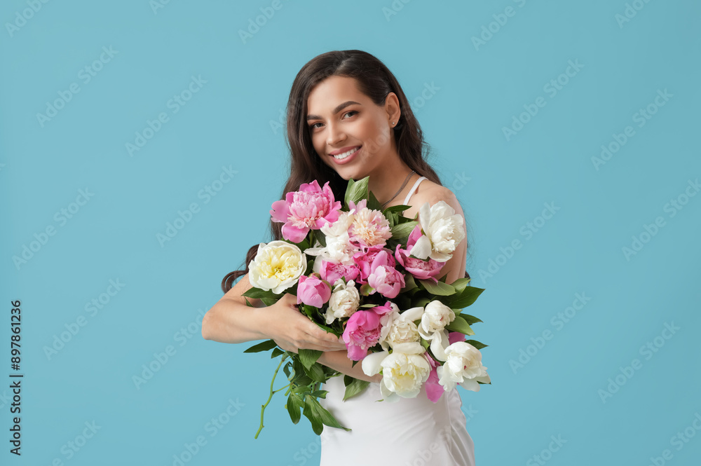 Beautiful young woman with bouquet of peony flowers on blue background Beautiful young woman with bouquet of peony flowers on blue background