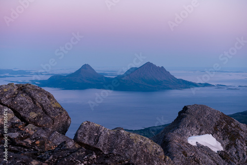 Midnight sun sunset view over Tomma island, in the archipelagio of Northern Norway, Helgeland. Smaltind, Breitind and Tortenviktind in the foreground. photo