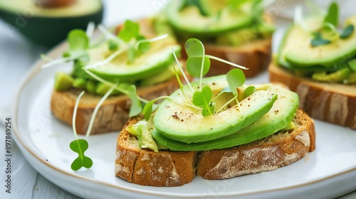 A delicious avocado toast topped with fresh microgreens, perfect for healthy snacking or breakfast.