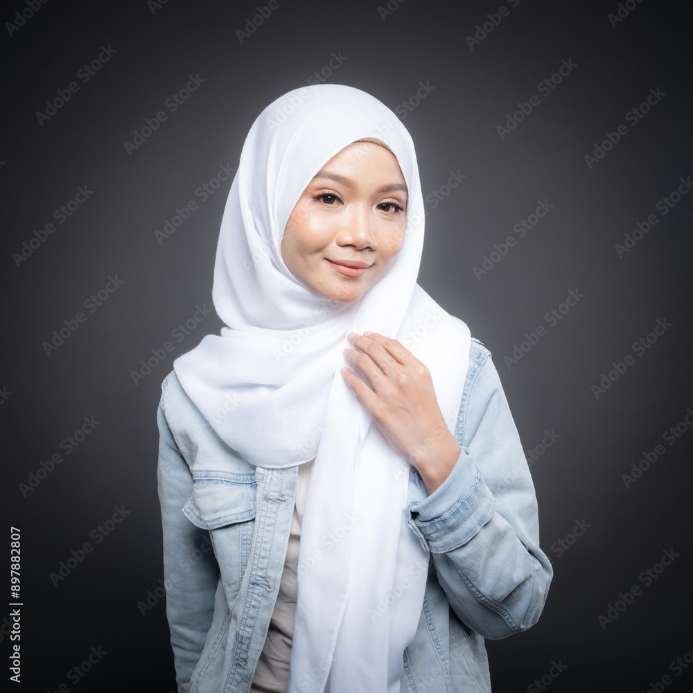 Portrait of a beautiful Malaysian and Indonesian Muslim young women wearing modern and casual wear with hijab on isolated studio background. Modern hijab fashion and beauty concept Portrait of a beautiful Malaysian and Indonesian Muslim young women wearing modern and casual wear with hijab on isolated studio background. Modern hijab fashion and beauty concept