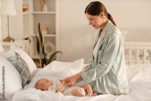 Mother holding her little b...