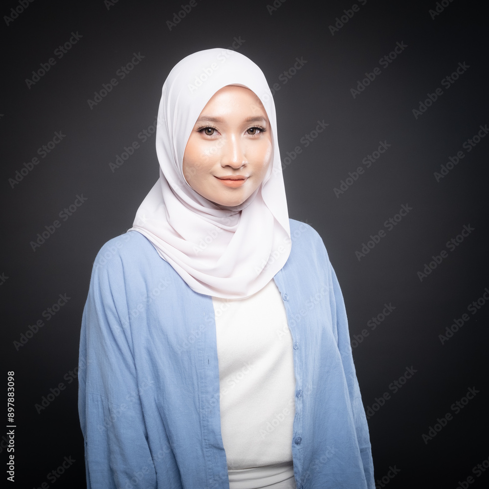 Portrait of a beautiful Malaysian and Indonesian Muslim young women wearing modern and casual wear with hijab on isolated studio background. Modern hijab fashion and beauty concept Portrait of a beautiful Malaysian and Indonesian Muslim young women wearing modern and casual wear with hijab on isolated studio background. Modern hijab fashion and beauty concept