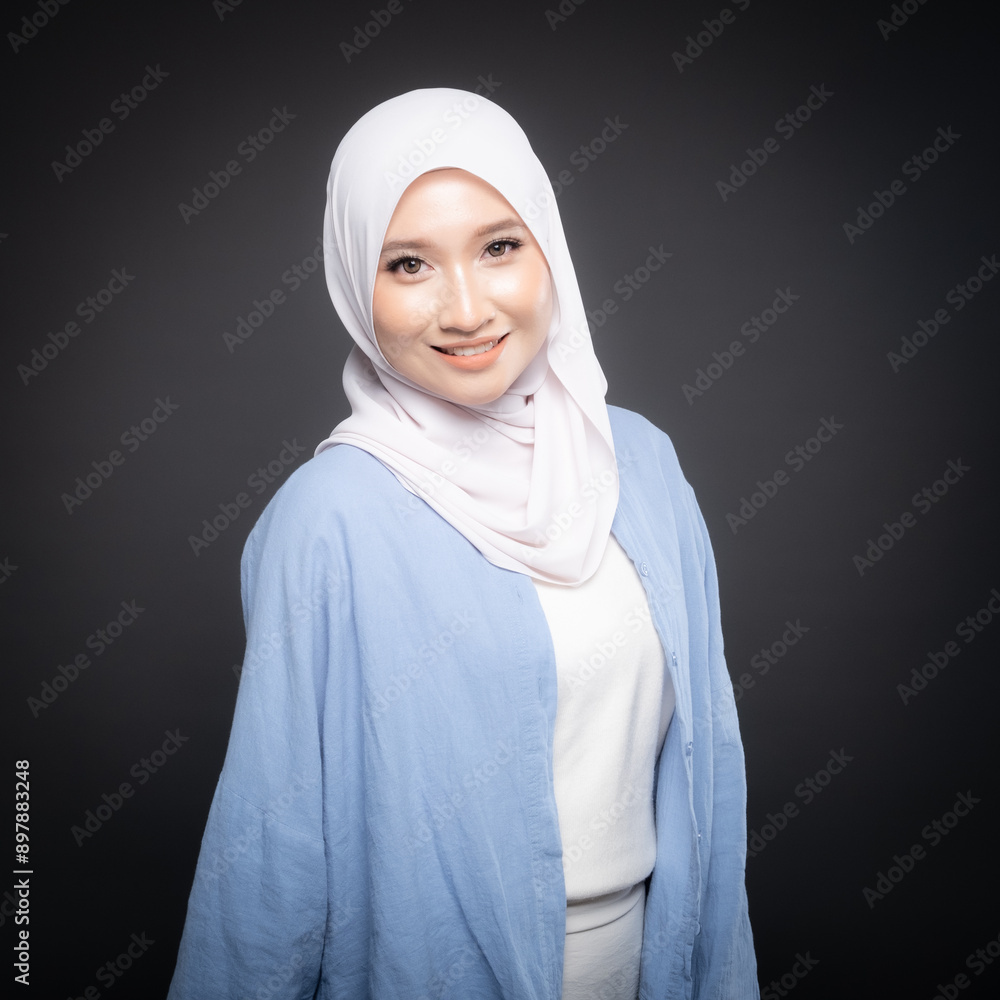 Portrait of a beautiful Malaysian and Indonesian Muslim young women wearing modern and casual wear with hijab on isolated studio background. Modern hijab fashion and beauty concept Portrait of a beautiful Malaysian and Indonesian Muslim young women wearing modern and casual wear with hijab on isolated studio background. Modern hijab fashion and beauty concept