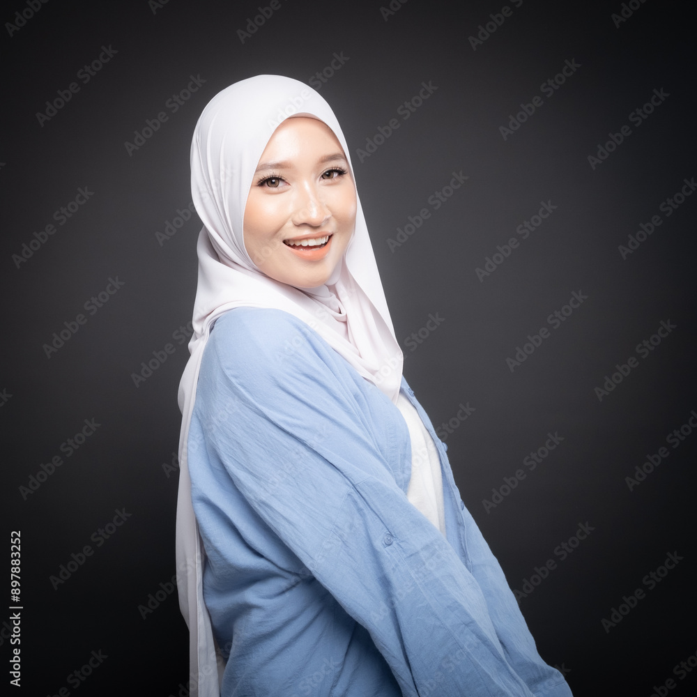 Portrait of a beautiful Malaysian and Indonesian Muslim young women wearing modern and casual wear with hijab on isolated studio background. Modern hijab fashion and beauty concept Portrait of a beautiful Malaysian and Indonesian Muslim young women wearing modern and casual wear with hijab on isolated studio background. Modern hijab fashion and beauty concept