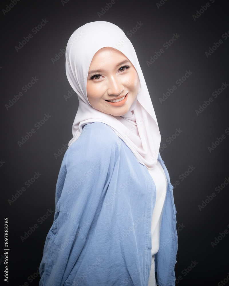 Portrait of a beautiful Malaysian and Indonesian Muslim young women wearing modern and casual wear with hijab on isolated studio background. Modern hijab fashion and beauty concept Portrait of a beautiful Malaysian and Indonesian Muslim young women wearing modern and casual wear with hijab on isolated studio background. Modern hijab fashion and beauty concept