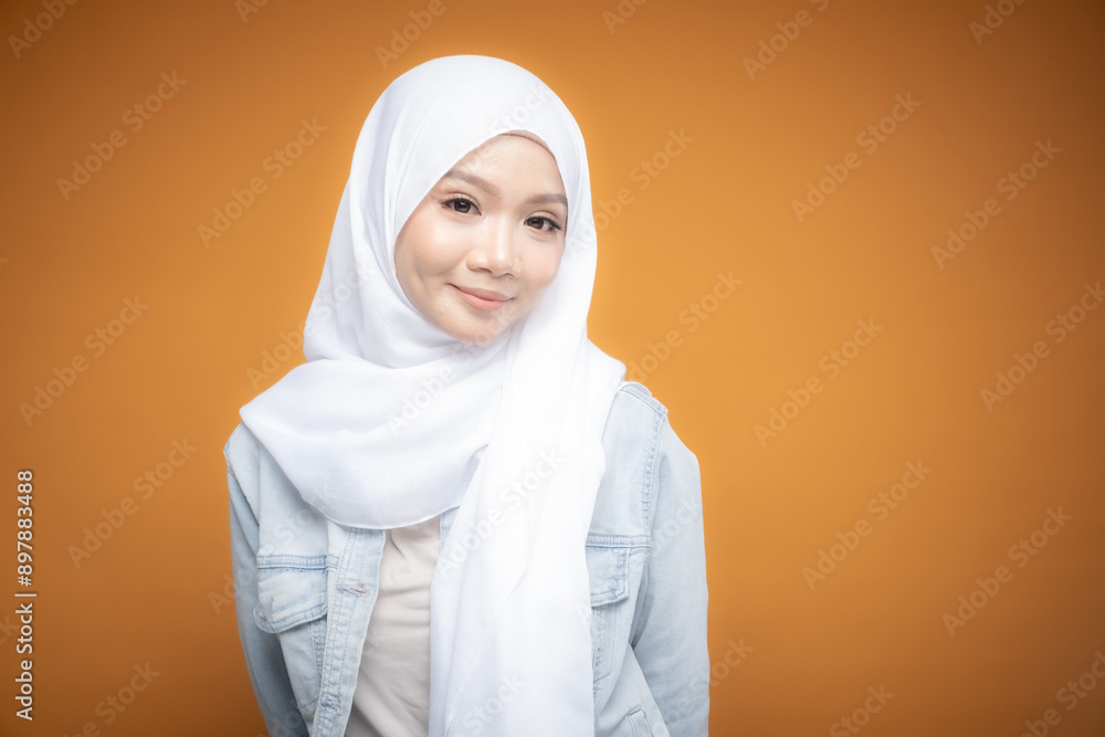 Portrait of a beautiful Malaysian and Indonesian Muslim young women wearing modern and casual wear with hijab on isolated studio background. Modern hijab fashion and beauty concept Portrait of a beautiful Malaysian and Indonesian Muslim young women wearing modern and casual wear with hijab on isolated studio background. Modern hijab fashion and beauty concept