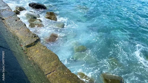 Kepulauan Sangihe, Indonesia - July 25th 2024 - beautiful waves breaking on the rocky shore. photo