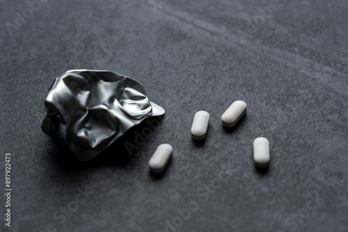 white pills on black background