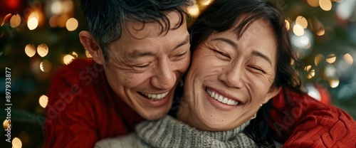 A Young Asian Couple Decorates The Christmas Tree And Prepares Food Together At Home, Filled With Festive Cheer