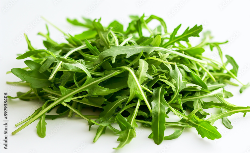 A pile of fresh arugula leaves on a white background. A pile of fresh arugula leaves on a white background.