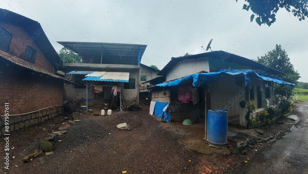 Fototapeta premium A rural village in Maharashtra during the rainy season with small huts and houses.