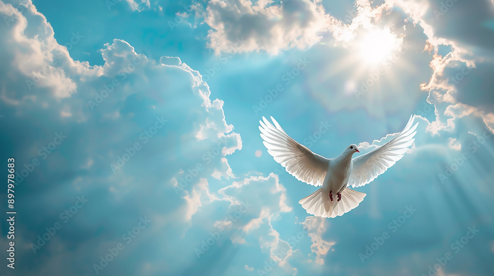 Fototapeta premium A white dove flying in a bright blue sky with rays of sunlight breaking through the clouds, symbolizing peace and freedom.