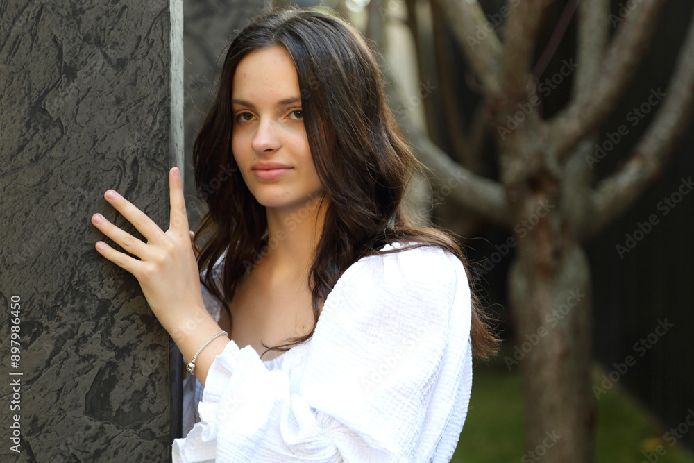 Fototapeta premium KYITeenage girl posing for a photographer. Young and beautiful teenage girl.