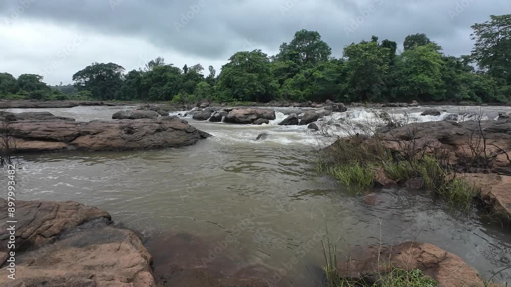 A serene stream flows over smooth rocks, creating a soothing sound of water cascading gently through the landscape. A serene stream flows over smooth rocks, creating a soothing sound of water cascading gently through the landscape.