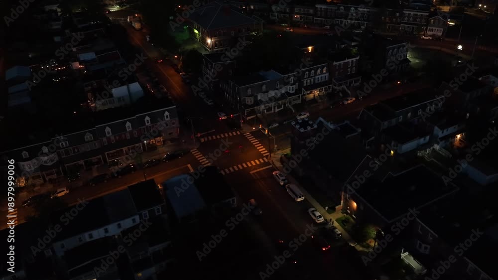 Aerial top down of traffic on junction in quiet small town of USA at night. Lighting lantern in housing area. Landing flight. Aerial top down of traffic on junction in quiet small town of USA at night. Lighting lantern in housing area. Landing flight.
