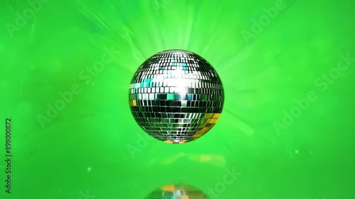 Spinning Disco Ball- A small disco ball spinning slowly in the center against a green screen. The reflective surfaces catch the light, casting tiny reflections and adding a party vibe