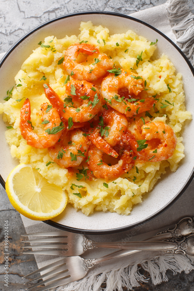 Hot Lemon Butter Shrimp with Mashed Potatoes closeup on the plate on the table, Vertical top view from above Hot Lemon Butter Shrimp with Mashed Potatoes closeup on the plate on the table, Vertical top view from above