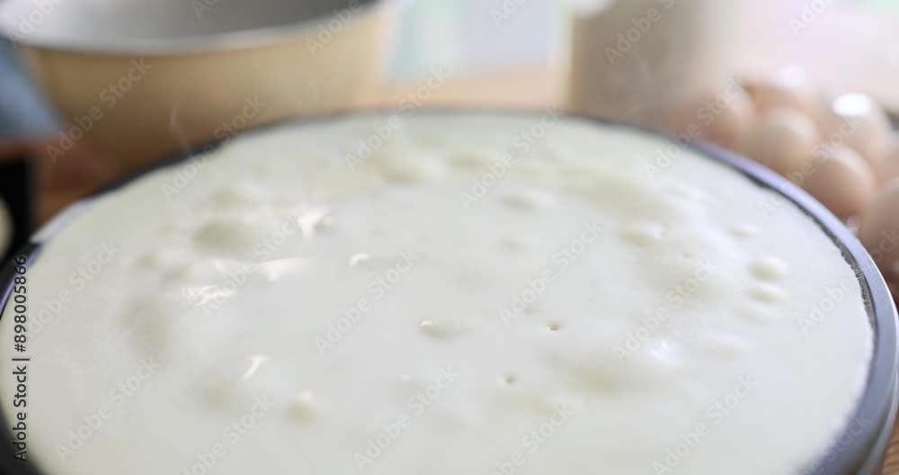 Pancake sizzles on surface of crepe maker in kitchen Pancake sizzles on surface of crepe maker in kitchen