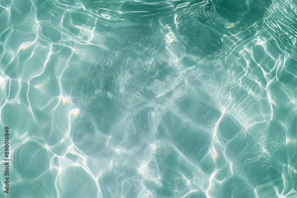 Obraz premium Calm turquoise water with gentle ripples and reflections, evoking a serene and refreshing atmosphere.