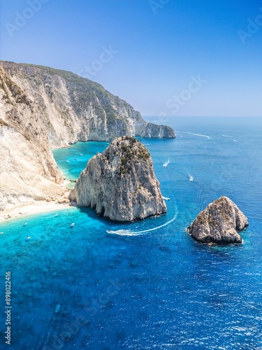 The drone aerial view of Mizithres beach, Zakynthos Island, Greece. The two conical huge rocks, that bounce from the crystal blue waters in Keri, are called the Small and Big Mitzithra.