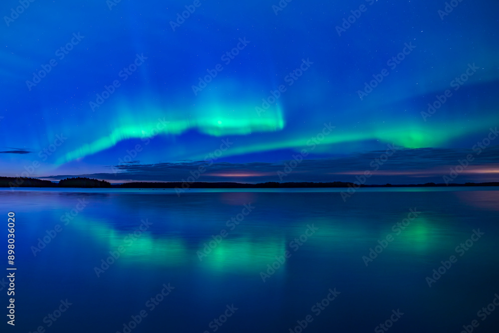 Northern lights dancing over calm lake in Farnebofjarden national park in north of Sweden. Northern lights dancing over calm lake in Farnebofjarden national park in north of Sweden.