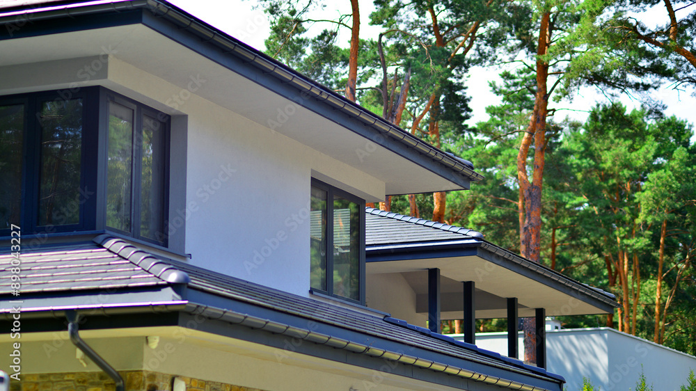 Obraz premium Upscale house in wooded area. Fragment of a single-family house facade.