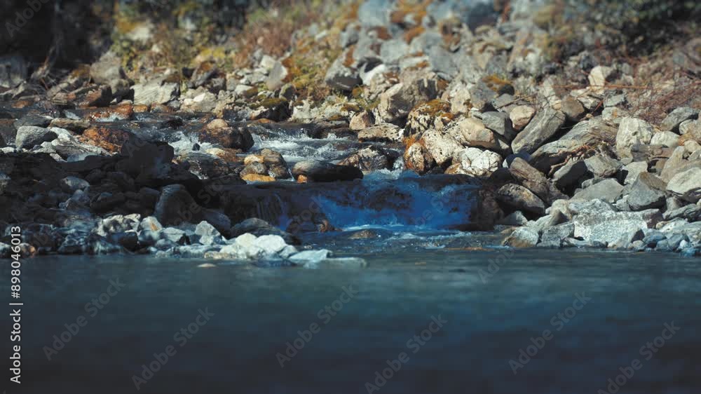 A small stream cascading over the rocky shore falls in the Naeroy Fjord. Slow-motion. A small stream cascading over the rocky shore falls in the Naeroy Fjord. Slow-motion.