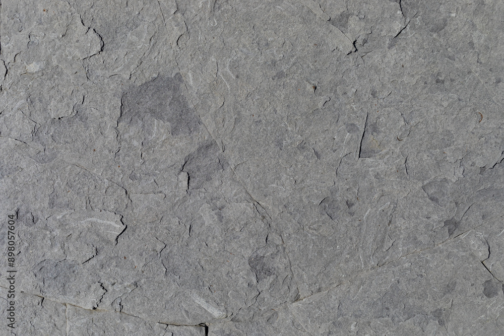 Sea-worn stone texture on a wild coastal beach. Sea-worn stone texture on a wild coastal beach.