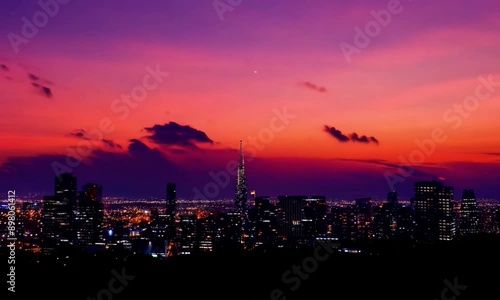 timelapse of a city skyline during a dramatic sunset.