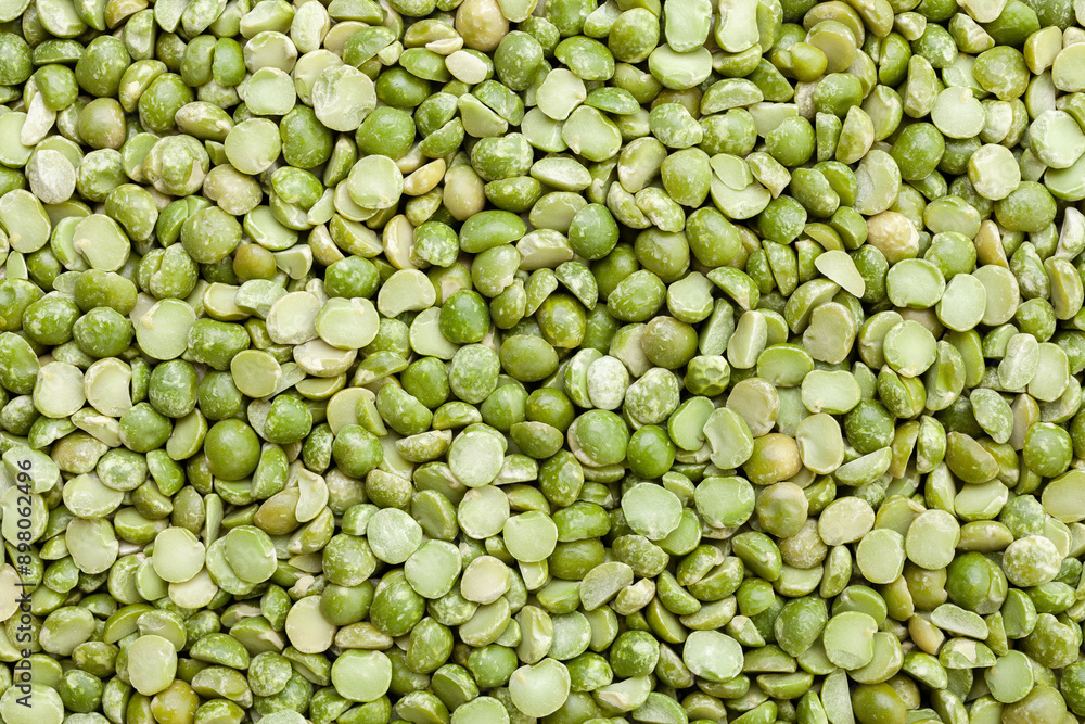Uncooked, split, green peas background. Dry peas grains. Top view Uncooked, split, green peas background. Dry peas grains. Top view