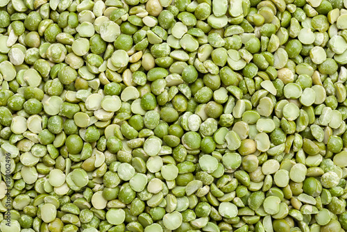 Uncooked, split, green peas background. Dry peas grains. Top view
