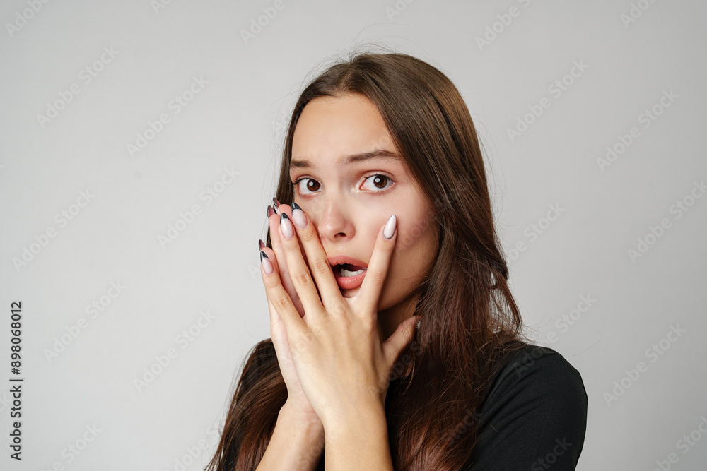 Young Woman Covering Her Face With Hands While Looking Scared Young Woman Covering Her Face With Hands While Looking Scared