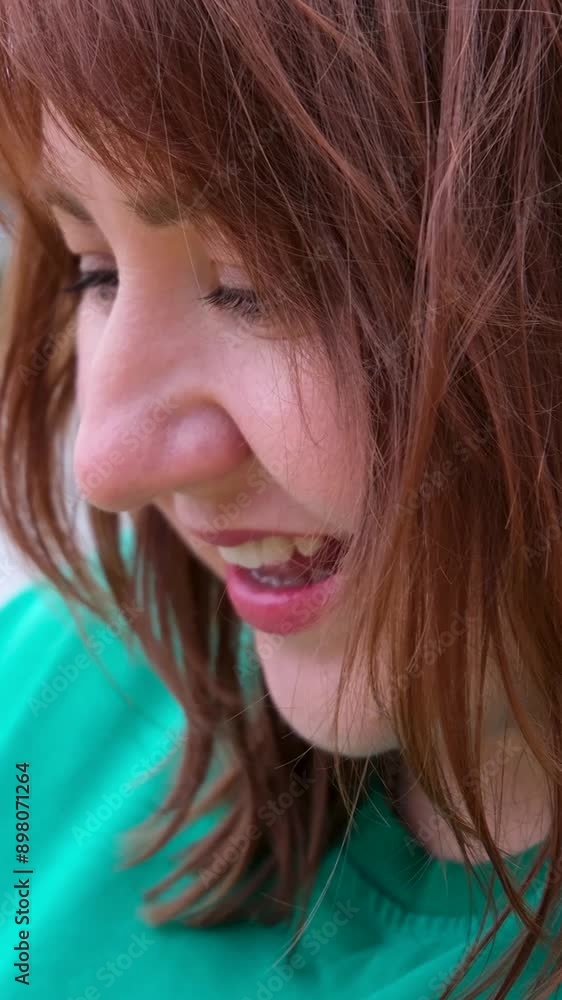 Surprised woman open her mouth Woman in a green T-shirt with red hair looks surprised at the camera Surprised woman open her mouth Woman in a green T-shirt with red hair looks surprised at the camera