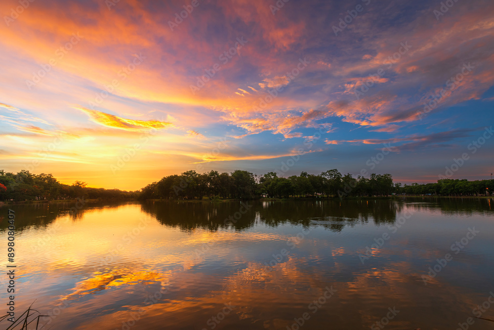 Fototapeta premium blue bright and orange yellow dramatic sunset sky in countryside texture background.