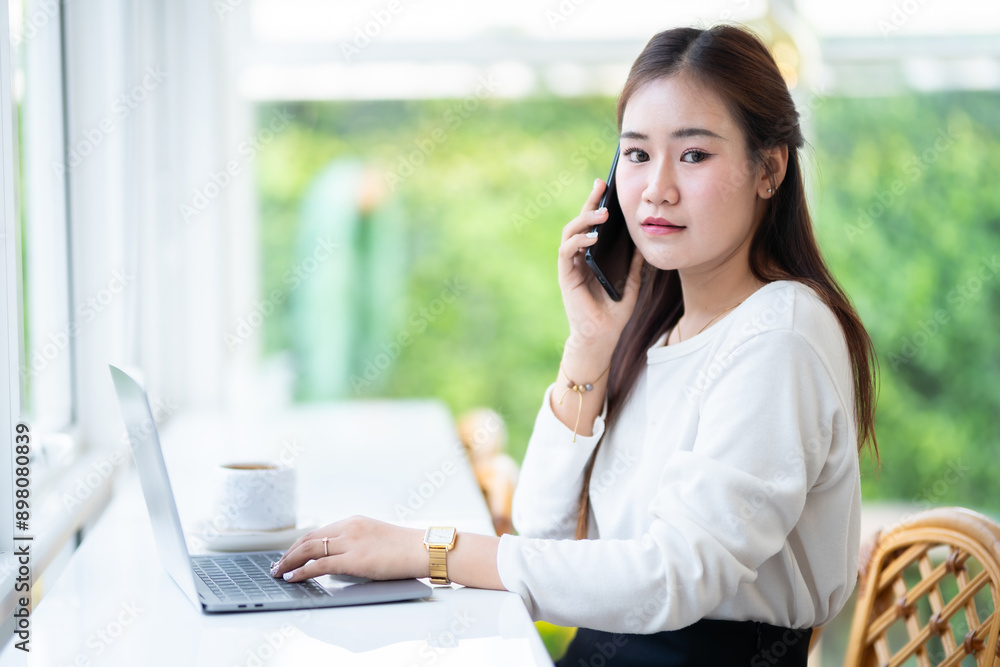 Happy of asian freelance people business female talking making using smartphone casual working with laptop computer and coffee cup in at the cafe, Business Lifestyle communication concept Happy of asian freelance people business female talking making using smartphone casual working with laptop computer and coffee cup in at the cafe, Business Lifestyle communication concept