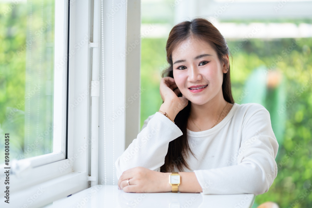 Portrait of beautiful happy Smiling asian woman relaxing sitting in cafe interior in coffee shop background,Business Lifestyle summer holiday concept Portrait of beautiful happy Smiling asian woman relaxing sitting in cafe interior in coffee shop background,Business Lifestyle summer holiday concept