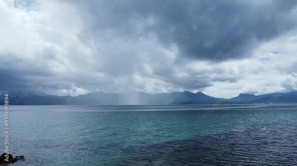 heavy rain over the sea with mountains in the background heavy rain over the sea with mountains in the background