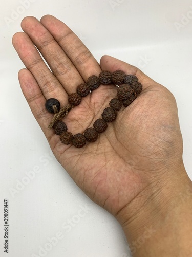 rudraksha seed that is shaped like a bracelet on the hand photo