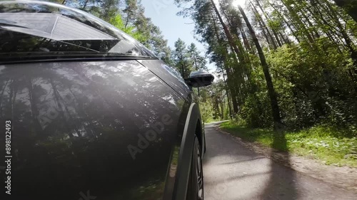 The camera is rigidly mounted on the body of a car moving in the forest